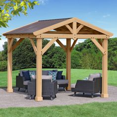 a wooden gazebo sitting on top of a lush green field