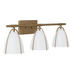 three light bathroom fixture with an aged brass finish and white glass shades on the bulbs