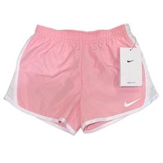 the nike shorts are pink and white with a small tag on it's side