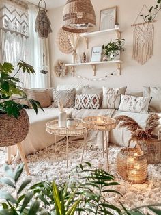 a living room filled with lots of furniture and plants on top of a white rug