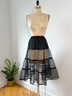 Vintage mid century era vintage black nylon ruffled petticoat with the mesh netted skirt & elastic waist.  A great vintage piece in excellent condition W: 24"-34" Hips: 34" L: 28" Netted Skirt, Petticoat Skirt, Net Skirt, Womens Skirts, Mesh Netting, Black Panels, Black Nylon, Black Nylons, Petticoat