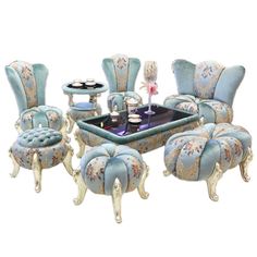 an ornately decorated dining room set with blue upholstered chairs and matching footstools