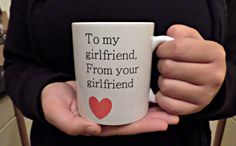 a person holding a coffee mug with the words to my girlfriend from your girlfriend