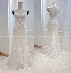 the back of a white wedding dress with feathers on it and an image of a mannequin