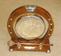 a wooden clock with metal parts on it