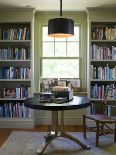 a room with bookshelves and a table in it