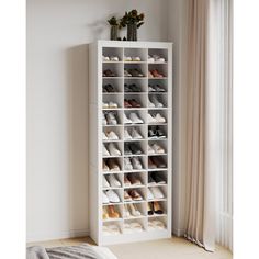 a white shoe rack with many pairs of shoes