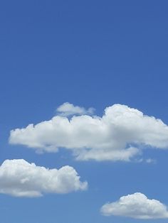 two airplanes flying in the sky with clouds