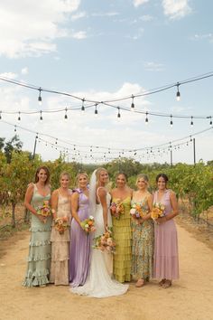 a group of women standing next to each other in front of a bunch of lights