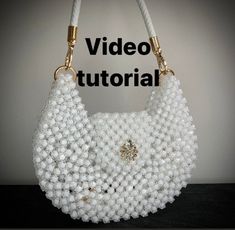 white beaded purse with gold hardware on display