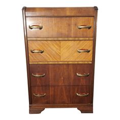 a wooden dresser with four drawers and brass handles