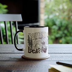 a coffee mug sitting on top of a wooden table