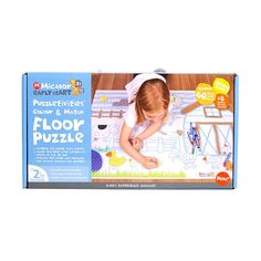 an image of a child playing with floor puzzle