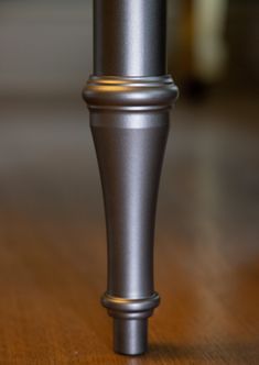 a close up of a metal object on a wooden table