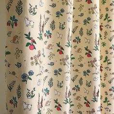 the curtain is decorated with flowers and animals