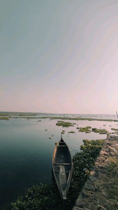 a small boat sitting on top of a body of water