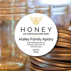 honey label sitting on top of jars filled with honey