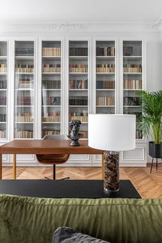 a living room filled with furniture and bookshelves covered in lots of bookcases