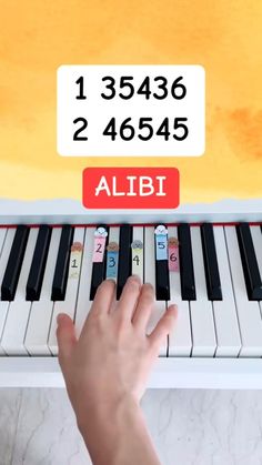 a person is playing the piano with their hand and fingers on it, which are also labeled alibi