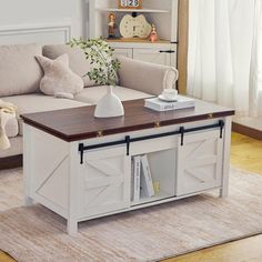 a living room with a couch, coffee table and bookshelf in the corner