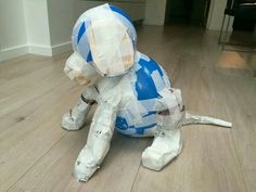 a paper mache dog is sitting on the floor