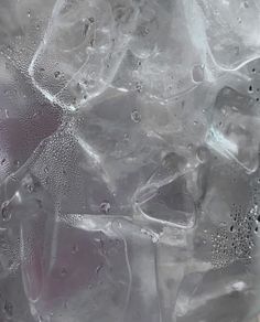 an ice cube with water and bubbles on it's surface, as seen from above