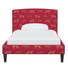 a bed with red horses on it and white sheets in front of the headboard