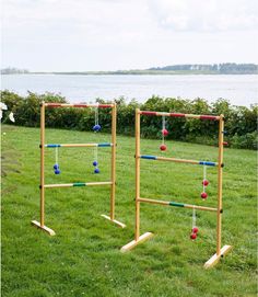 an outdoor game set up in the grass with balls and tees attached to it