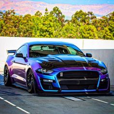 a blue and purple car parked in a parking lot