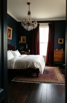 a bedroom with a chandelier hanging from the ceiling and a bed in it