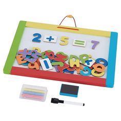 a magnetic board with numbers and magnets on it next to markers, pencils and erasers