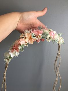 a hand is holding a flower crown