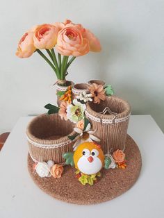 there is a small vase with flowers in it on top of a mat that looks like a basket