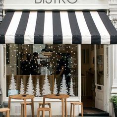 a store front with black and white striped awning