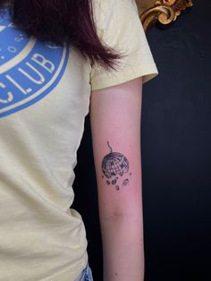 a woman with a tattoo on her arm that has a hot air balloon in it