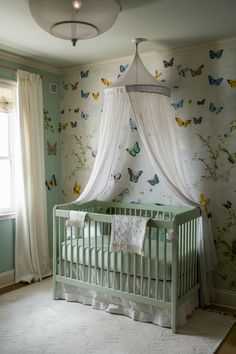 a baby's room decorated in green and white with butterflies all over the walls