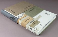 three books with different types of paint sitting on top of each other in front of a gray background