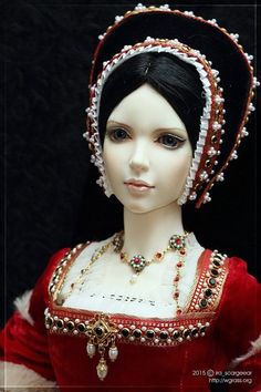 a doll wearing a red dress and headdress