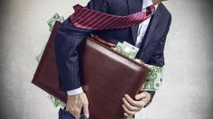 a man in a suit and tie carrying a briefcase full of money on his back