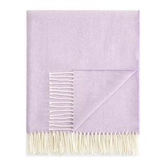 a purple and white blanket with fringes