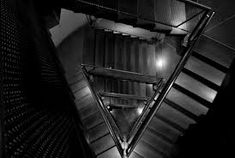 an overhead view of a staircase with metal handrails