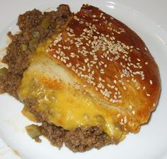 a cheeseburger with ground beef and onions on a white plate