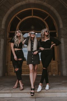 three women in black outfits posing for the camera with their hands on their hipss