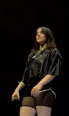 a woman sitting on top of a chair in tights