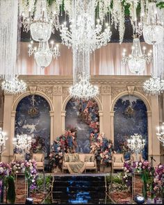 an elaborately decorated room with chandeliers and flowers