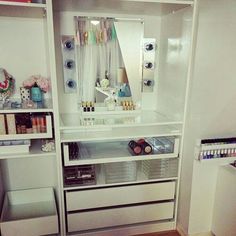 the inside of a makeup cabinet with drawers and shelves on each side, containing cosmetics