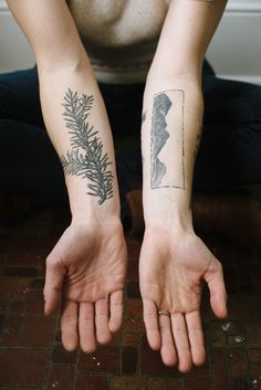 a person with two tattoos on their arms and one is holding his hand out to the camera