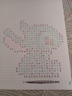 a cross - stitch pattern on top of a piece of paper