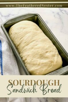 a loaf of bread sitting in a pan on top of a white tablecloth with the words, sourdough sandwich bread