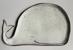 a ceramic plate with a whale design on it